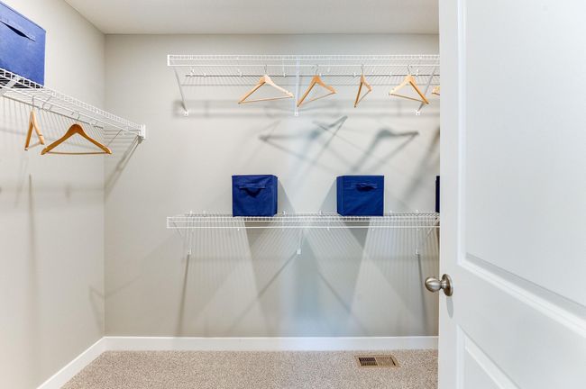 An extension of the primary suite, this private and spacious bathroom contains a double-vanity, an oversized stand-in shower, soaking tub, private stool room and access to a HUGE walk-in closet!! Photo of model home, color and options will vary. | Image 29