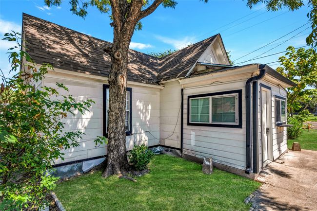 View of front facade with a front yard and an attached garage | Image 5