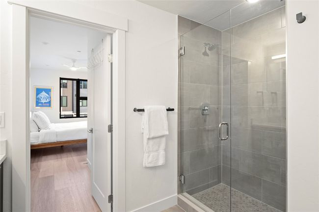 Bathroom with hardwood / wood-style floors and a shower with door | Image 22