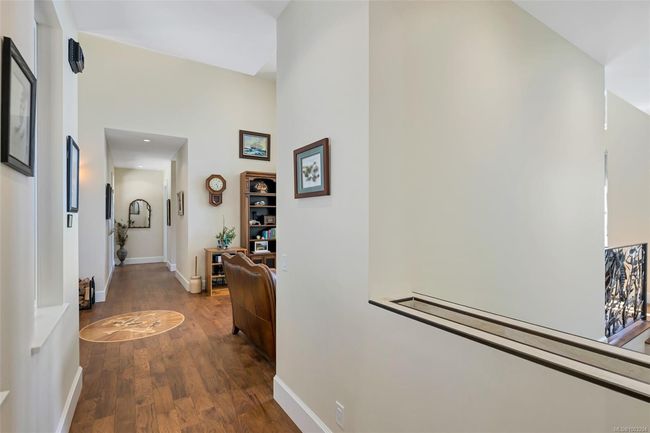 Hall featuring dark wood-type flooring and a high ceiling | Image 67