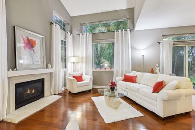 The interior boasts neutral painted walls, elegant light fixtures and engineered maple flooring. | Image 3