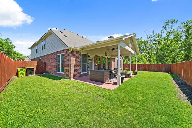 The large fenced backyard offers both privacy and versatility, with plenty of green space for play, gardening, or future enhancements. | Image 46