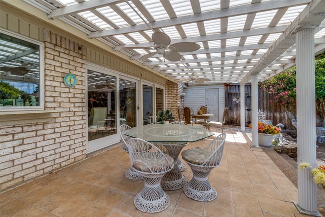 View of patio featuring a pergola, outdoor dining space, and a ceiling fan | Image 19