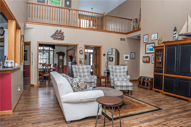 Living room featuring baseboards, visible vents, and wood finished floors | Image 4