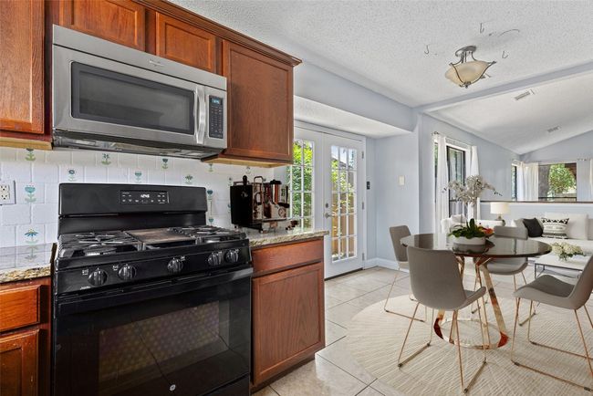 *virtually staged* The cabinetry brings in warmth with a rich, wood-toned finish that plays nicely against the soft tile underfoot. | Image 11