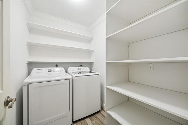 Large laundry room with plenty of shelving for storage | Image 17