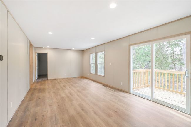 Unfurnished living room with recessed lighting, a decorative wall, and light wood-style floors | Image 8
