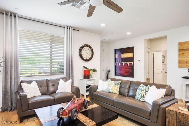 Living room with visible vents, ceiling fan, light wood finished floors, and recessed lighting | Image 11