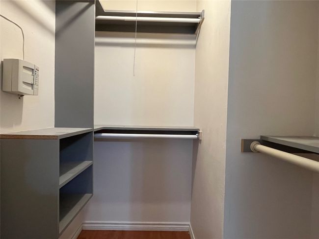 Walk in closet featuring wood finished floors | Image 16