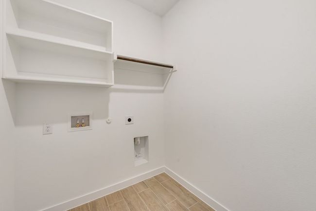 Laundry room featuring hookup for a gas dryer, electric dryer hookup, wood finish floors, and washer hookup | Image 19