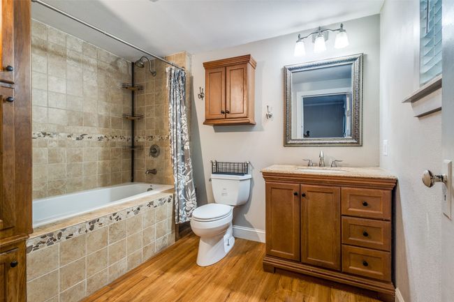 The secondary bathroom features a large soaking shower/tub combo. | Image 16