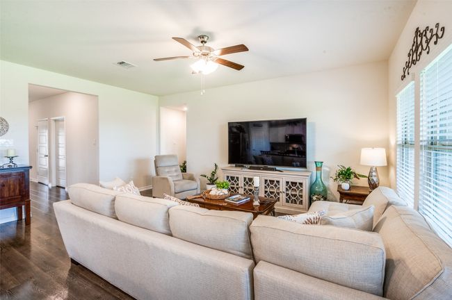 Living room with dark wood finished floors and ceiling fan | Image 8