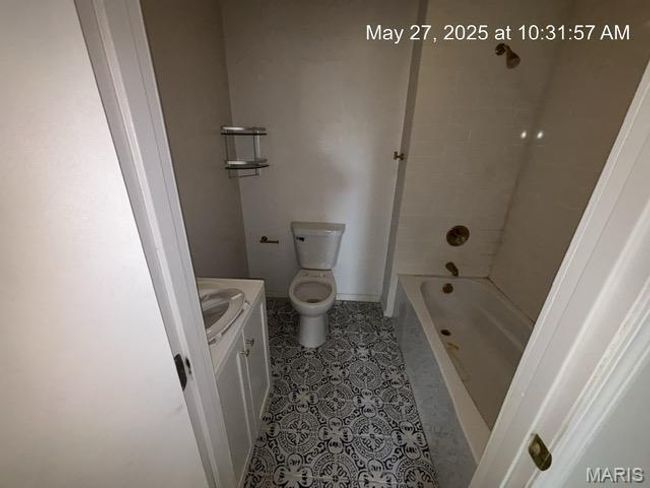 Full bathroom with vanity, toilet, shower / bath combination, and tile patterned floors | Image 8