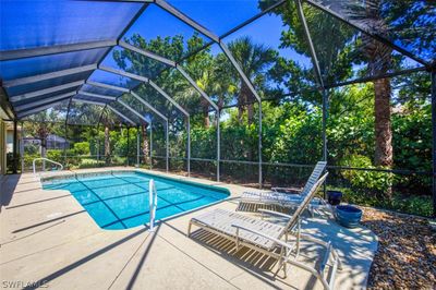 View of swimming pool with a lanai and a patio area | Image 2