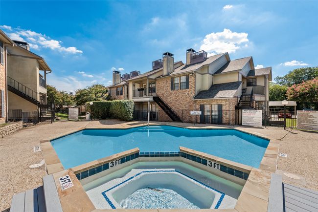 Community pool featuring stairs and a hot tub | Image 26