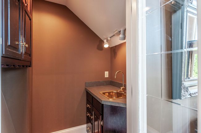 Your new home features a wine room with sink and ample storage. | Image 17