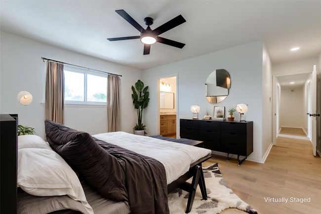Bedroom featuring light wood-style floors, recessed lighting, ensuite bath, and a ceiling fan | Image 14