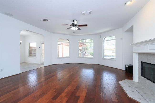 Bow ay window area in Family room offers plenty of furniture solutions and brightness with triple windows | Image 10