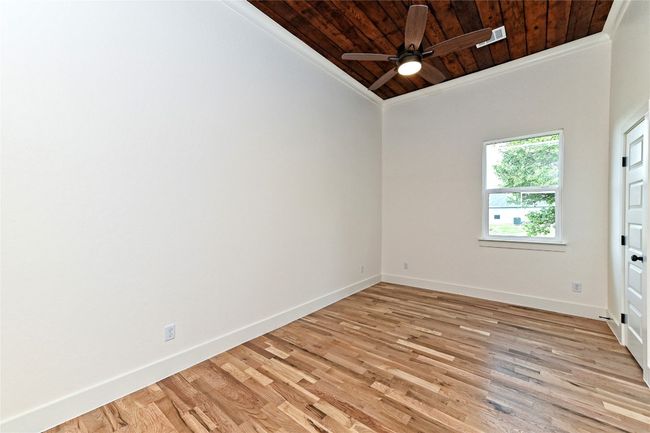 Second Bedroom featuring wooden ceiling, ornamental molding, ceiling fan, and light wood finished floors | Image 22