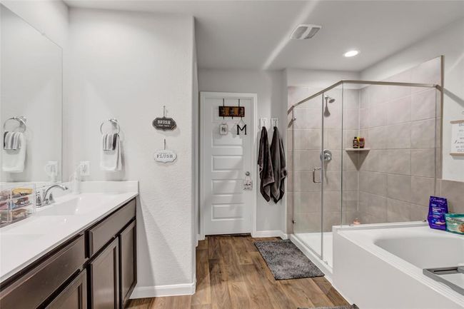Primary bathroom has tub and separate shower and a large walk in closet | Image 30