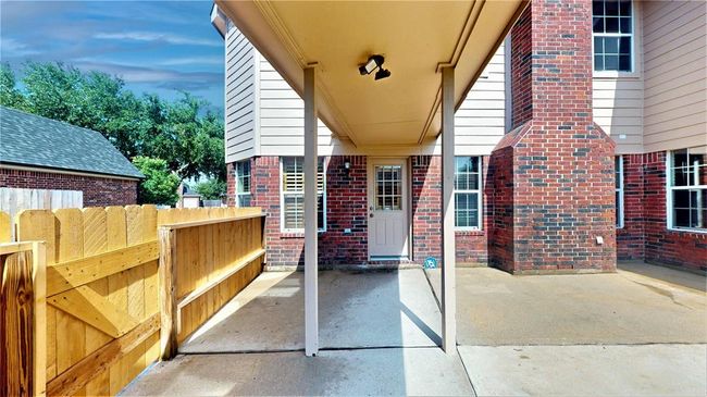 Charming back patio with a covered walkway leading to the detached garage. | Image 41