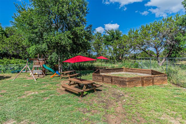 View of yard with a playground and a vegetable garden | Image 40