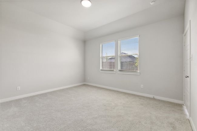 Spare room with light carpet, baseboards, and vaulted ceiling | Image 10