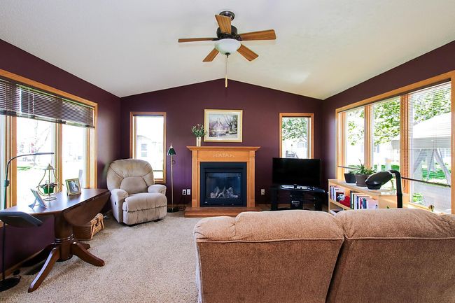 The four-season porch features a gas fireplace. A door leads out to the 11'x27' concrete patio in the backyard. | Image 5