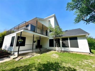 Back of house featuring a balcony and a yard | Image 1