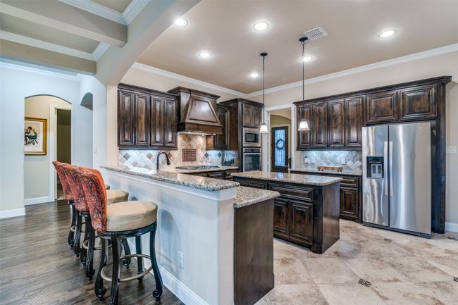 42" tall cabinets and bottom cabinets including the island's cabinetry provide ample storage. The counter tops provide much prep space and can also be used for buffet dinners. Stylish lighting and undermount lighting. The refrigerator will stay with the house. | Image 15