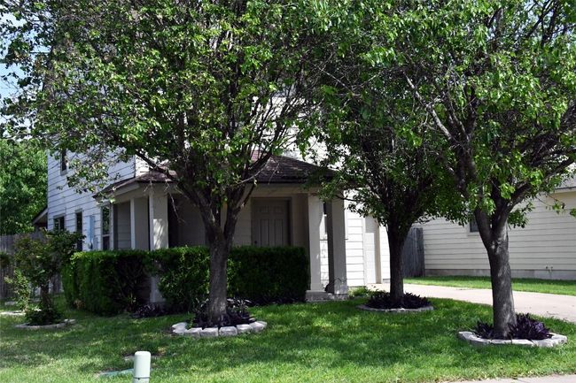 Obstructed view of property featuring a front yard and a garage | Image 33