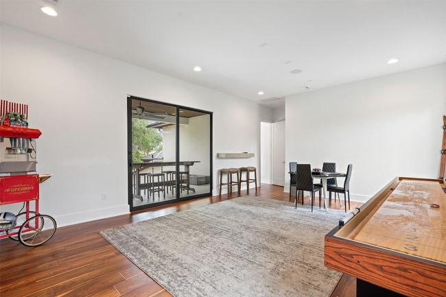 The upstairs game room opens to a private covered balcony with pool views. | Image 37