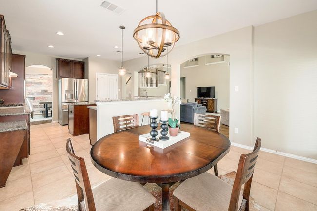 This inviting breakfast nook is bathed in natural light, creating a warm and welcoming space to start your day or casually dine with family and friends | Image 17