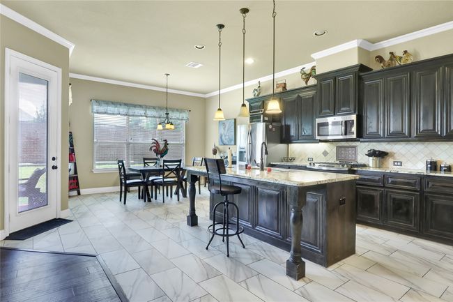 View of kitchen and breakfast area. | Image 4