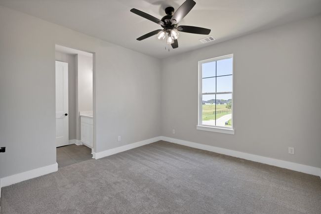 Carpeted empty room featuring baseboards and ceiling fan | Image 33