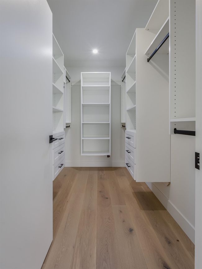 Walk in closet with light wood-style flooring | Image 22