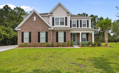 Craftsman house featuring a front yard | Image 1