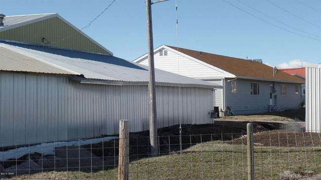 View of side of property with metal roof and fence | Image 18