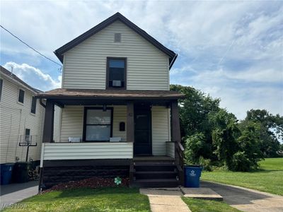 View of front of house featuring covered porch and a front lawn | Image 1