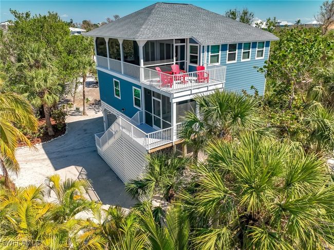 Back of house featuring a sunroom, roof with shingles, driveway, and a balcony | Image 7