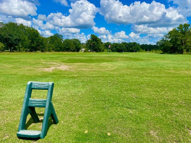 Area Amenities: HTL Driving Range of home's community with a yard and view of scattered trees | Image 19