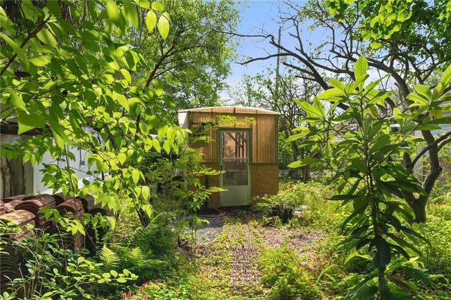 View of outdoor structure featuring greenhouse. | Image 28