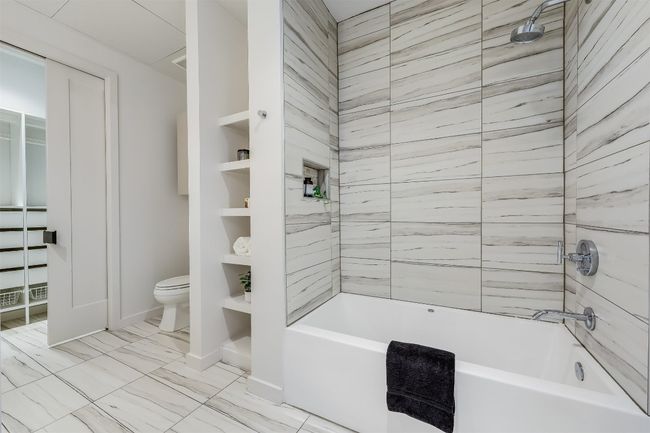 The shower and soaking tub create a perfect balance of relaxation and practicality, offering a spacious, modern setup where you can unwind in the tub or enjoy a quick, refreshing shower with clean, minimalist lines | Image 24