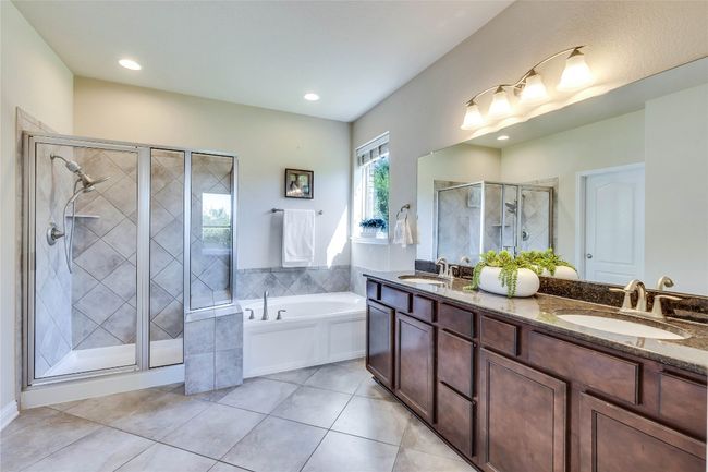 Primary bathroom with both step in shower and soaking tub. Double vanity sinks | Image 14