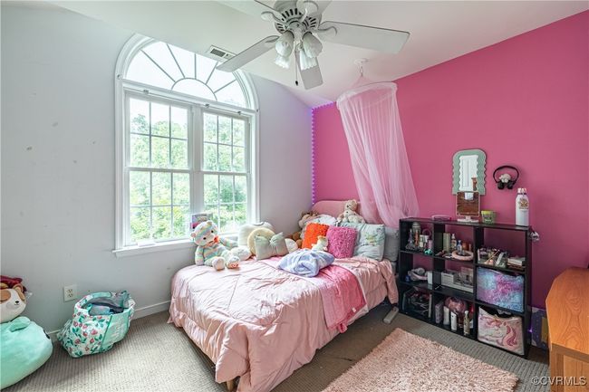 Bedroom featuring carpet floors, a ceiling fan, and vaulted ceiling | Image 12