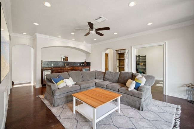 Living area featuring arched walkways, visible vents, recessed lighting, and a ceiling fan | Image 33