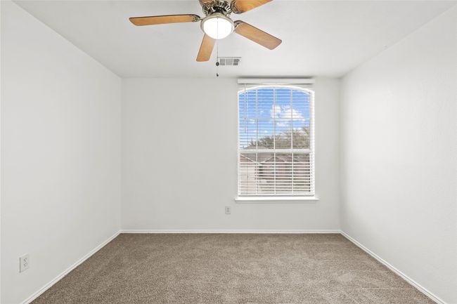 Carpeted spare room featuring baseboards, visible vents, and ceiling fan | Image 18