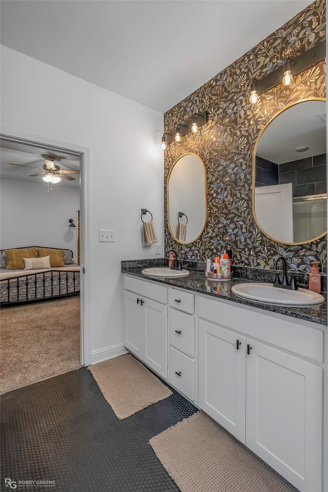 Bathroom featuring a sink, baseboards, a ceiling fan, and double vanity | Image 16