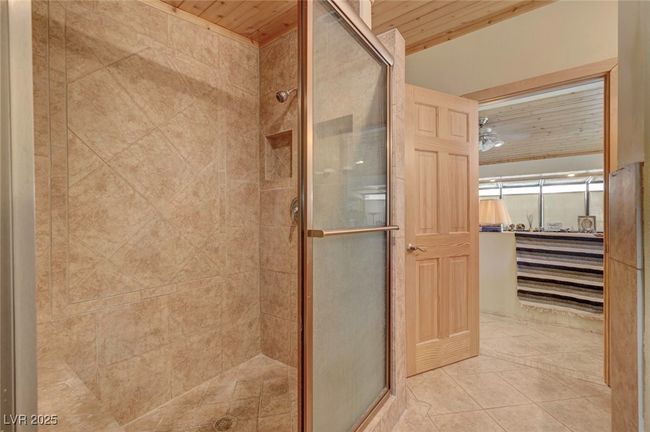 Full bathroom with wooden ceiling, a stall shower, and tile patterned floors | Image 46