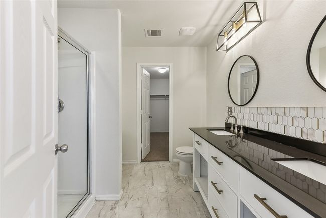 Bathroom featuring a sink, visible vents, a shower stall, and marble finish floor | Image 18